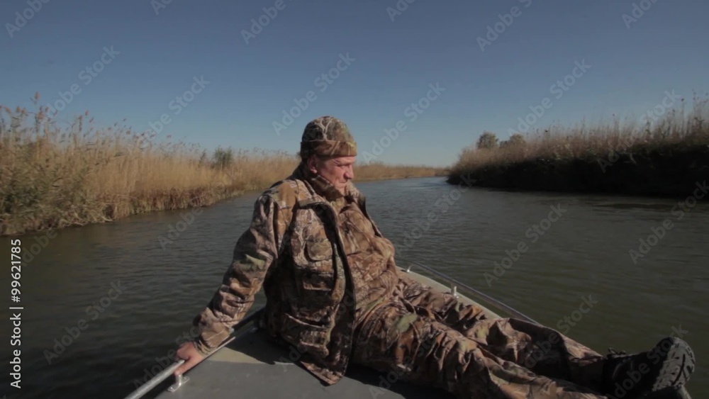 The fisherman goes on the bow motor boat The fisherman goes on the bow motor boat