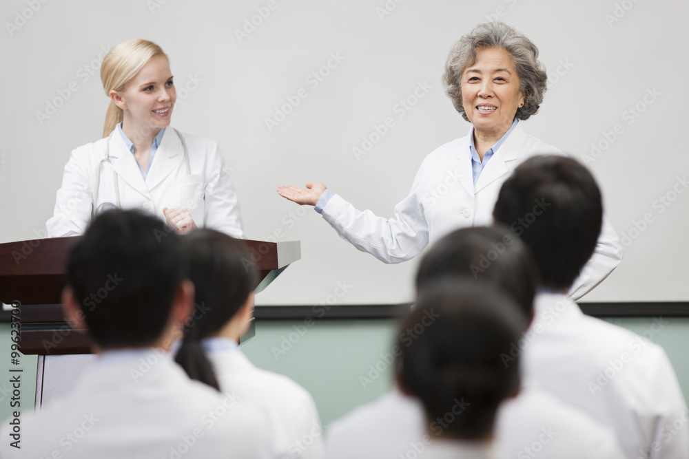 Fototapeta premium Medical workers giving speech in boardroom