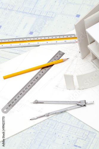 Architectural model and other office stationery on blueprint