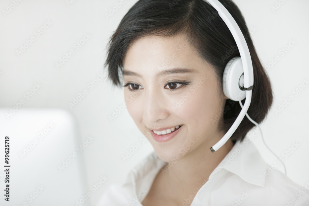 Cheerful businesswoman with headset in office Cheerful businesswoman with headset in office