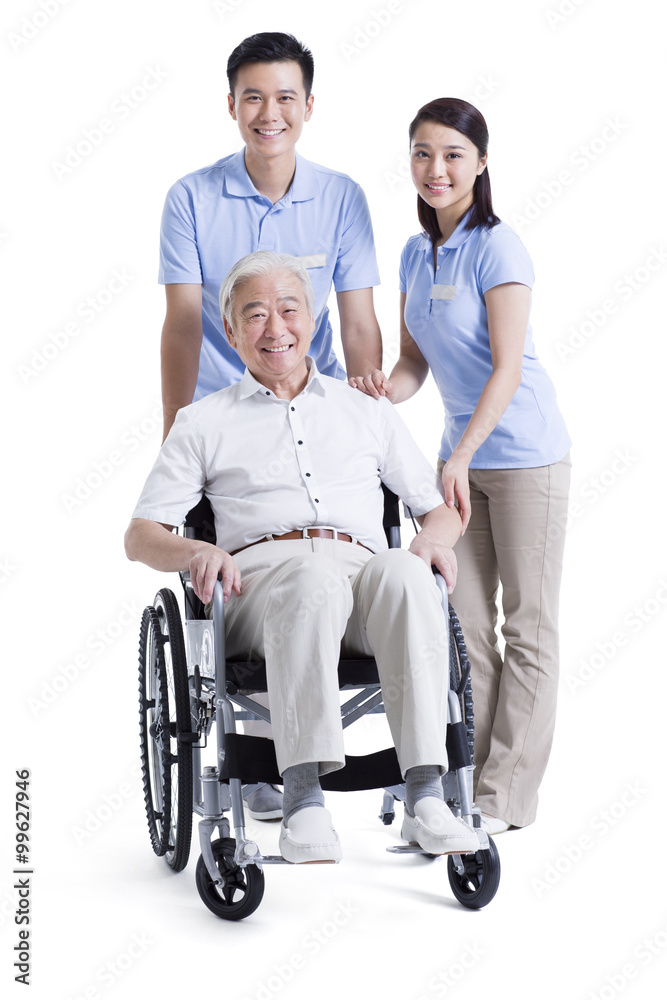 Nursing assistants taking care of senior in wheelchair Nursing assistants taking care of senior in wheelchair