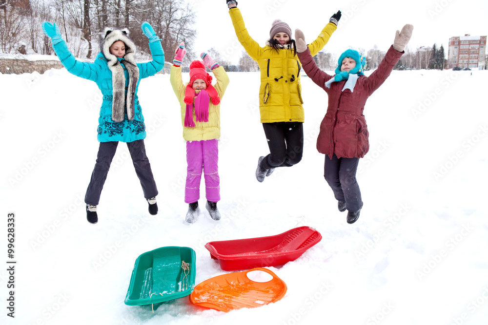 Obraz premium Merry company of children jumping on a winter afternoon walk