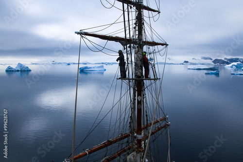 sailors aloft in a tallship in Antarctica photo