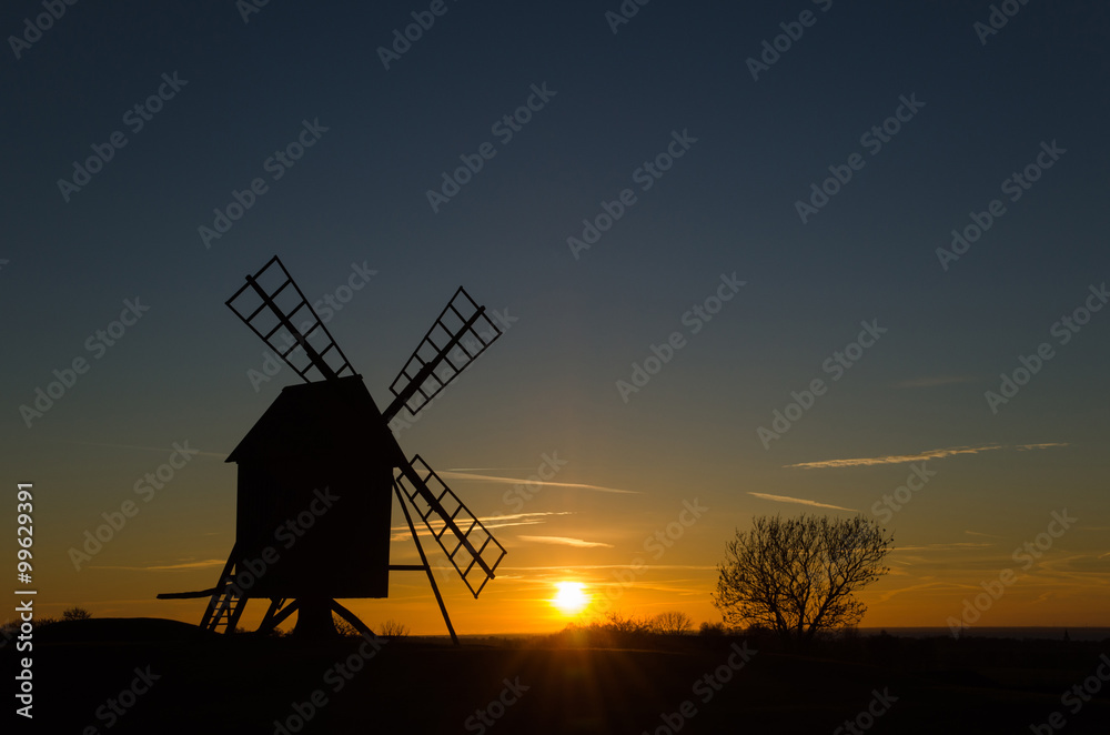 Sunset with silhouette of an old windmill