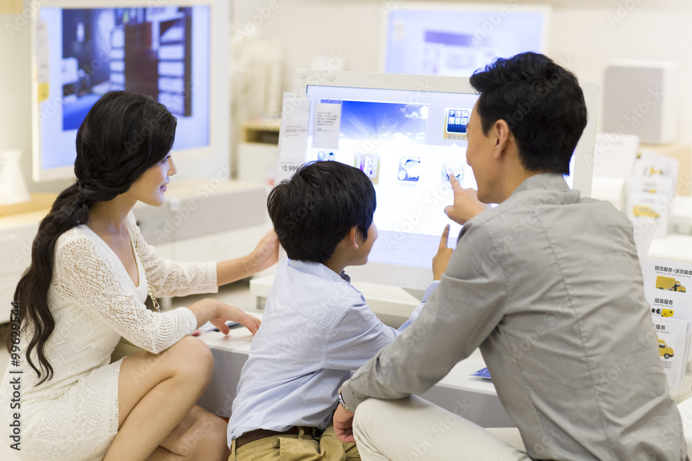 Happy family touching the computer screen Happy family touching the computer screen