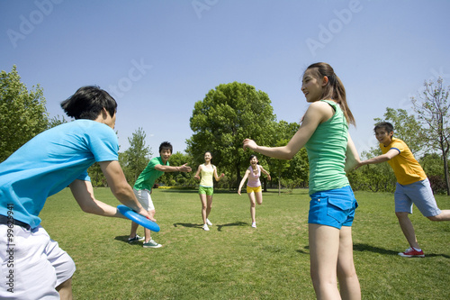 A group of friends playing with a Frisbee