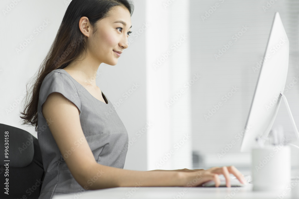 Young businesswoman working on computer in the office Young businesswoman working on computer in the office
