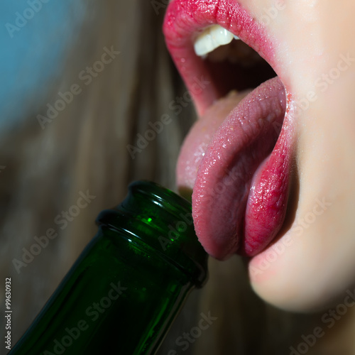 Woman licking bottle photo