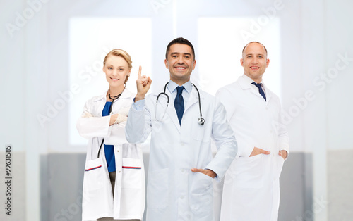 group of doctors at hospital pointing finger up