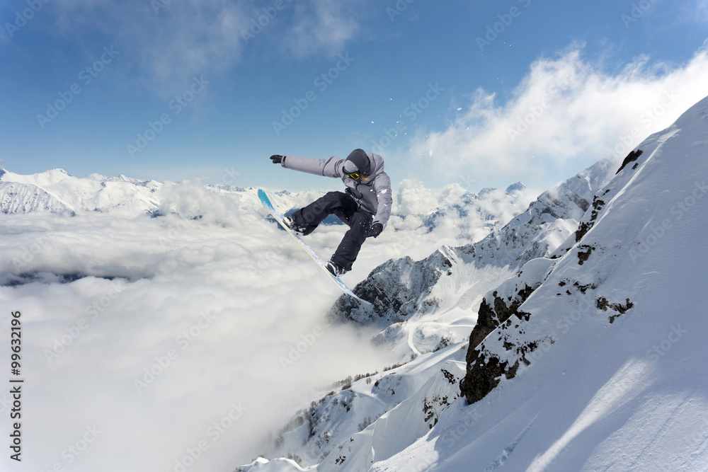 Flying snowboarder on mountains. Extreme sport. Flying snowboarder on mountains. Extreme sport.