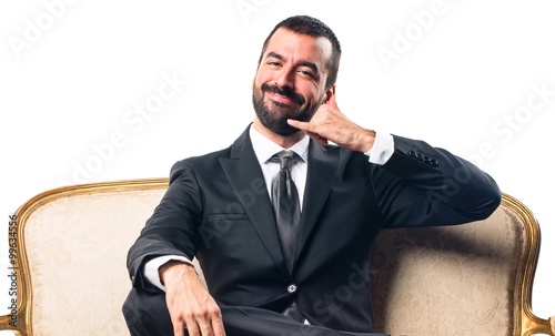 Businessman making phone gesture