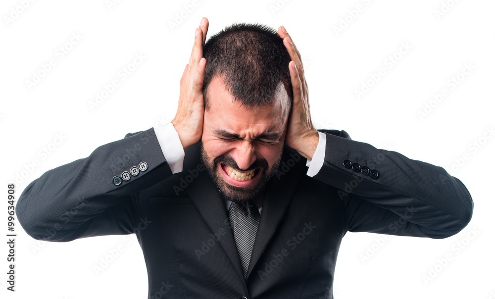 Businessman covering his ears Businessman covering his ears