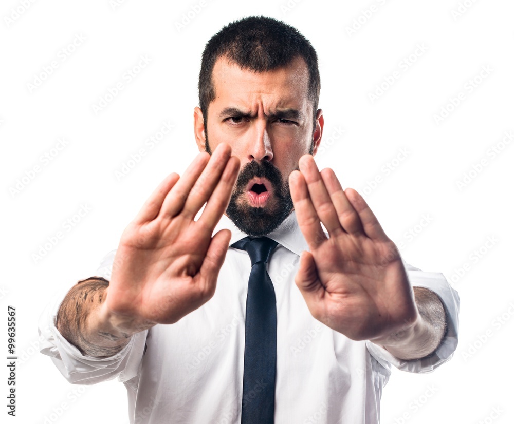 Businessman making stop sign Businessman making stop sign