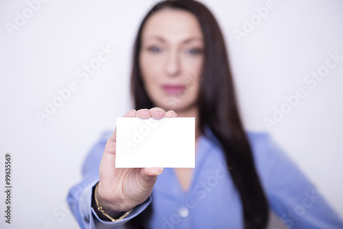 beautiful brunette business woman in working attire posing on grey background