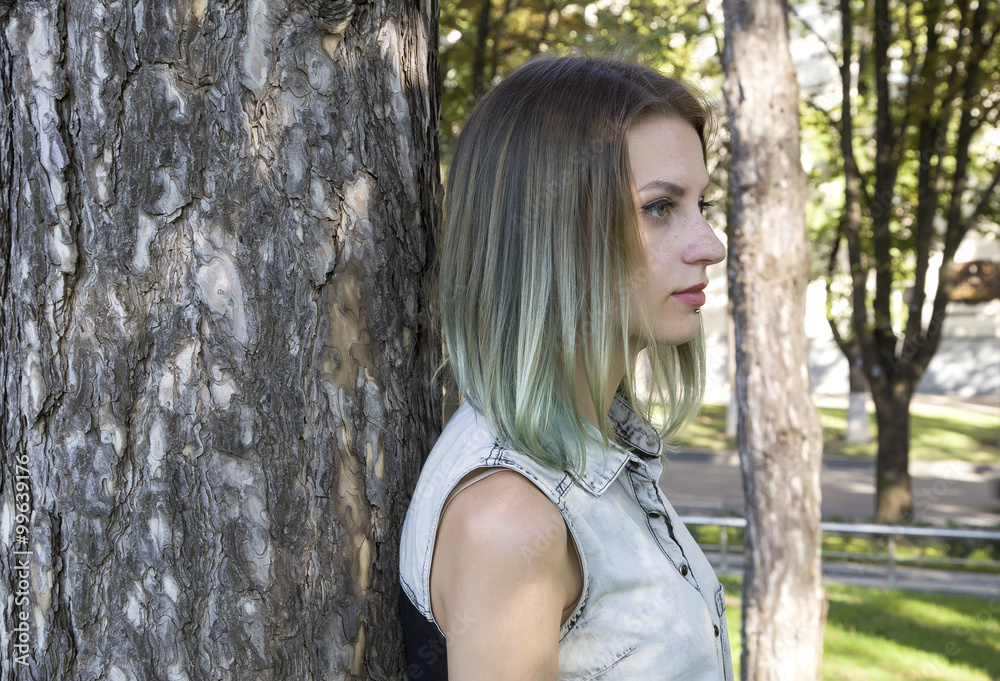 Blue haired gothic girl walk in park