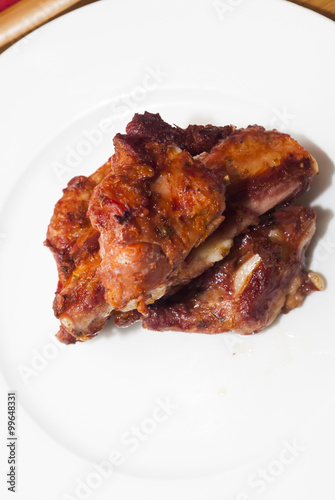 Roasted pork ribs on a white plate