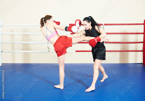 Muay thai woman fighting at training ring