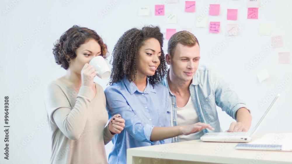 Three coworkers are working with digital information. Three coworkers are working with digital information.