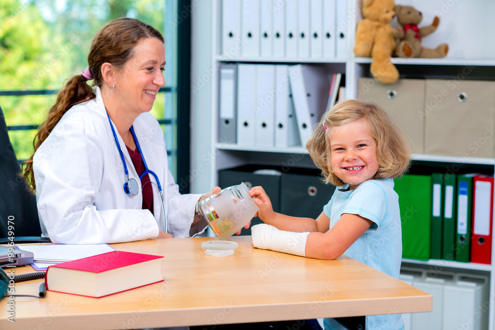 female pediatrician has candies for a little girl female pediatrician has candies for a little girl