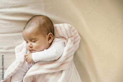 Cute Baby Girl sleeping in the Crib photo