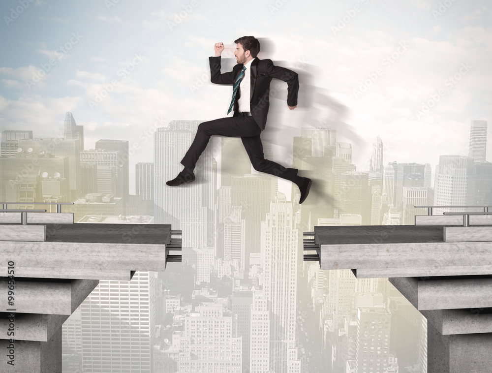 Energetic business man jumping over a bridge with gap Energetic business man jumping over a bridge with gap