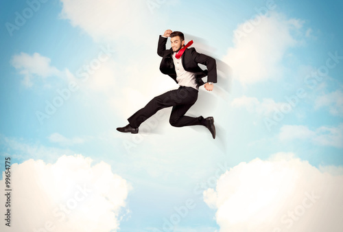 Wallpaper Mural Business person jumping over clouds in the sky Torontodigital.ca