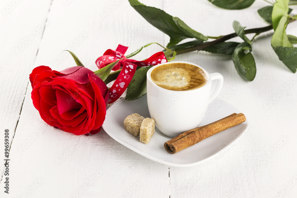 Cup of coffee, red rose, sugar and cinnamon on a white wooden ba Cup of coffee, red rose, sugar and cinnamon on a white wooden ba