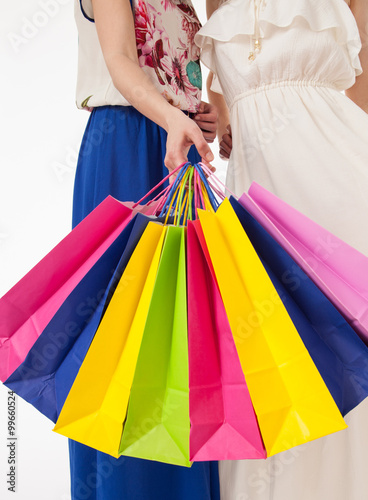 Young women with multicolored shopping bags