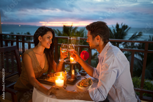 couple enjoying a romantic dinner by candlelight