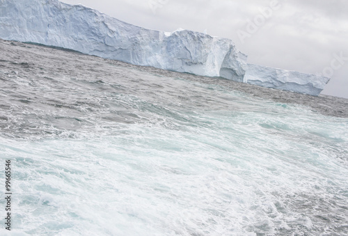 Ships wake passing iceberg