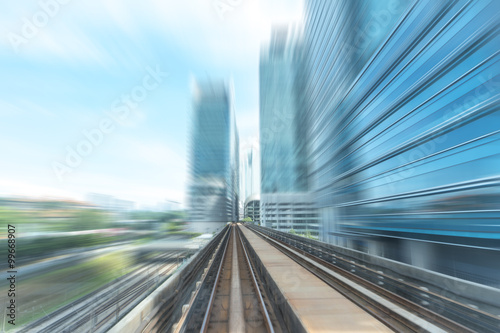 Light railway and modern building with blur motion