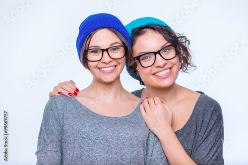 Happy-looking sisters are hugging together. photo