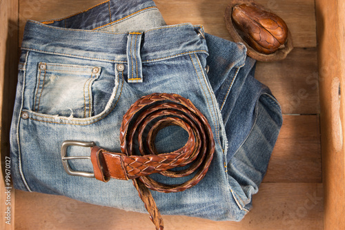 Vintage Filter : Male jeans and Leather belt in wood box .
