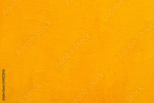 Concrete wall old yellow color for texture background.