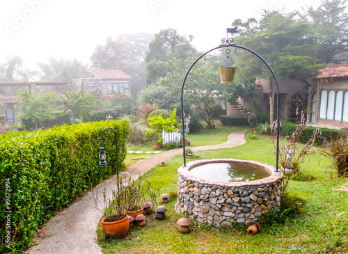 vintage style water well decorated in a garden
