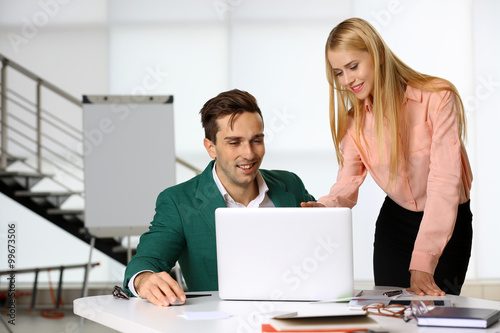 A businessman and businesswoman working in a conference room