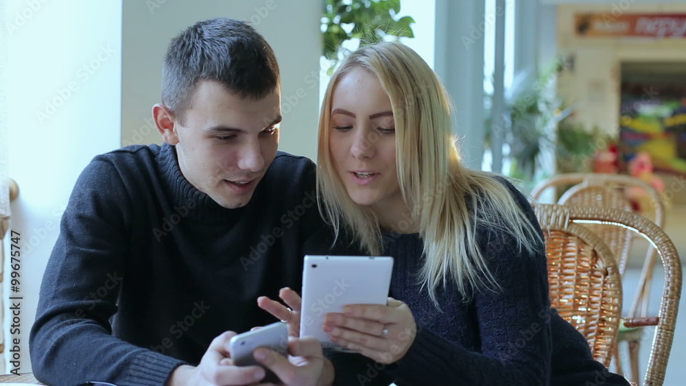 Young boy and girl with the tablet and phone Young boy and girl with the tablet and phone