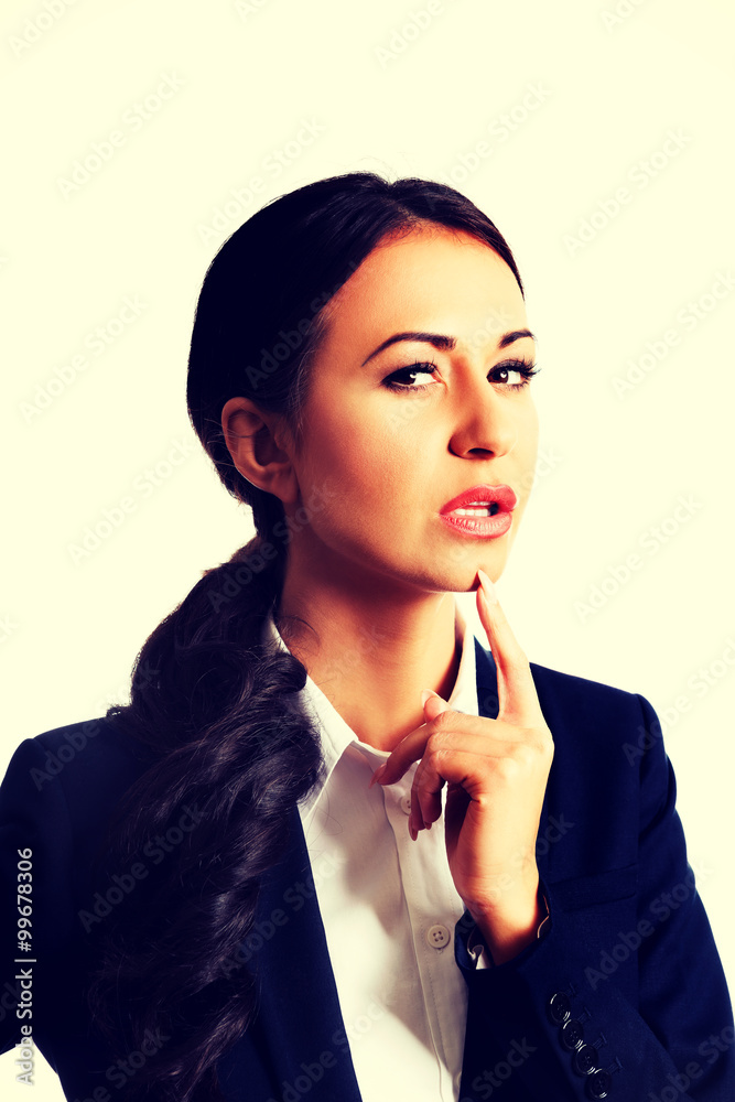 Thoughtful businesswoman with finger under chin Thoughtful businesswoman with finger under chin