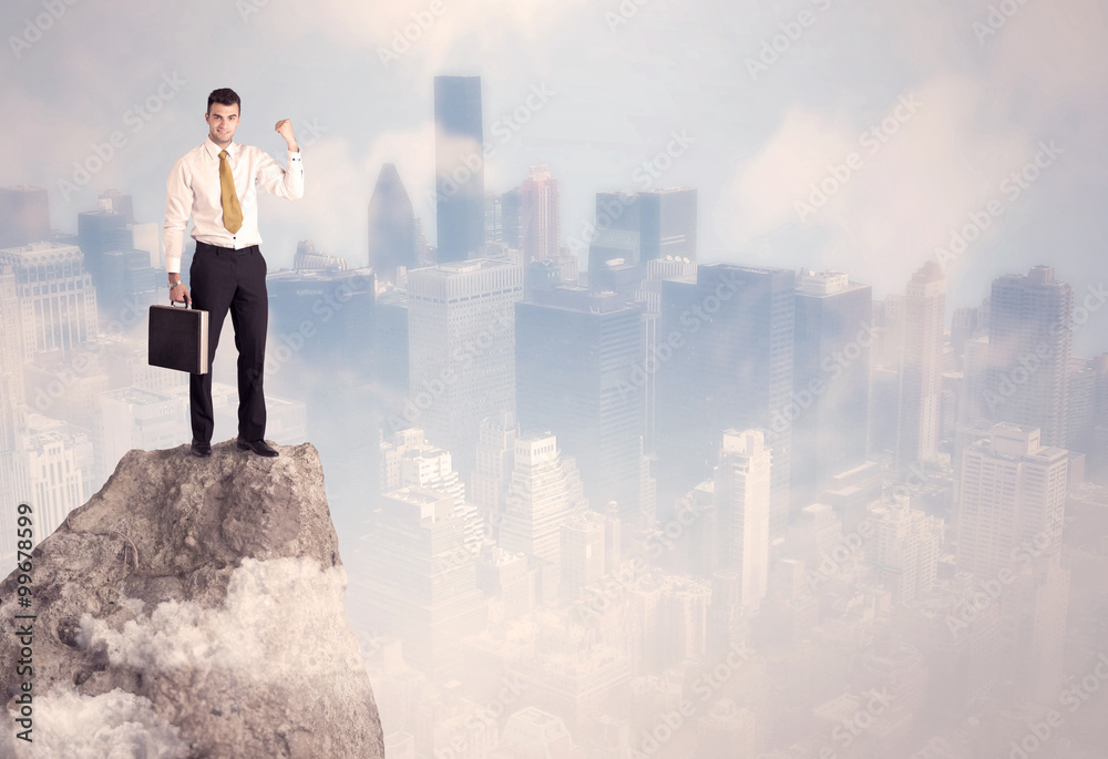Winner urban businessman on top of stone Winner urban businessman on top of stone