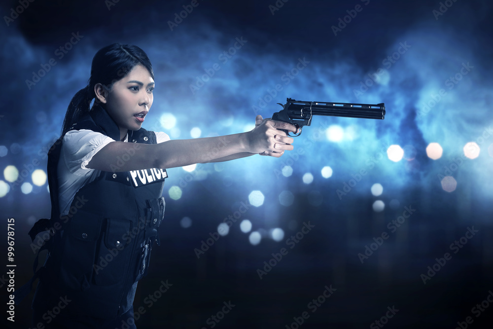 Beautiful police woman holding gun