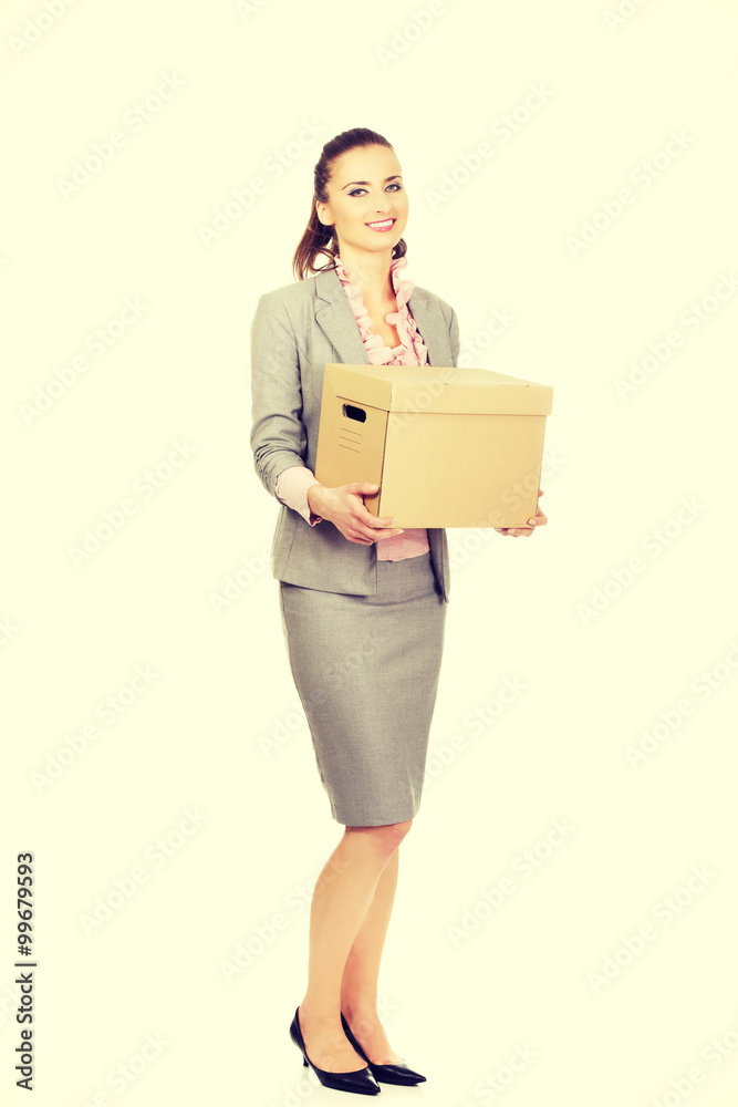 Sad businesswoman carrying box. Sad businesswoman carrying box.