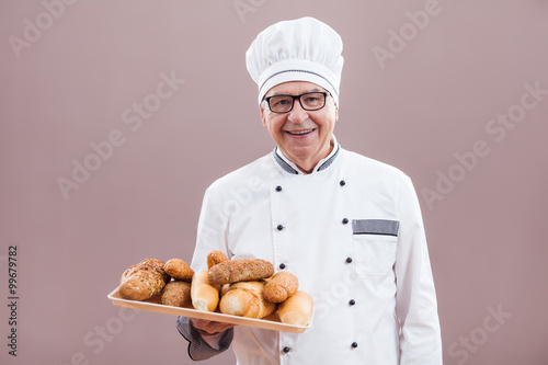 Portrait of happy baker chef in working uniform