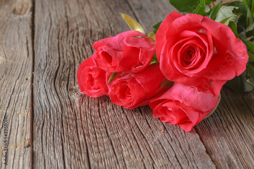 Pink roses on wooden table