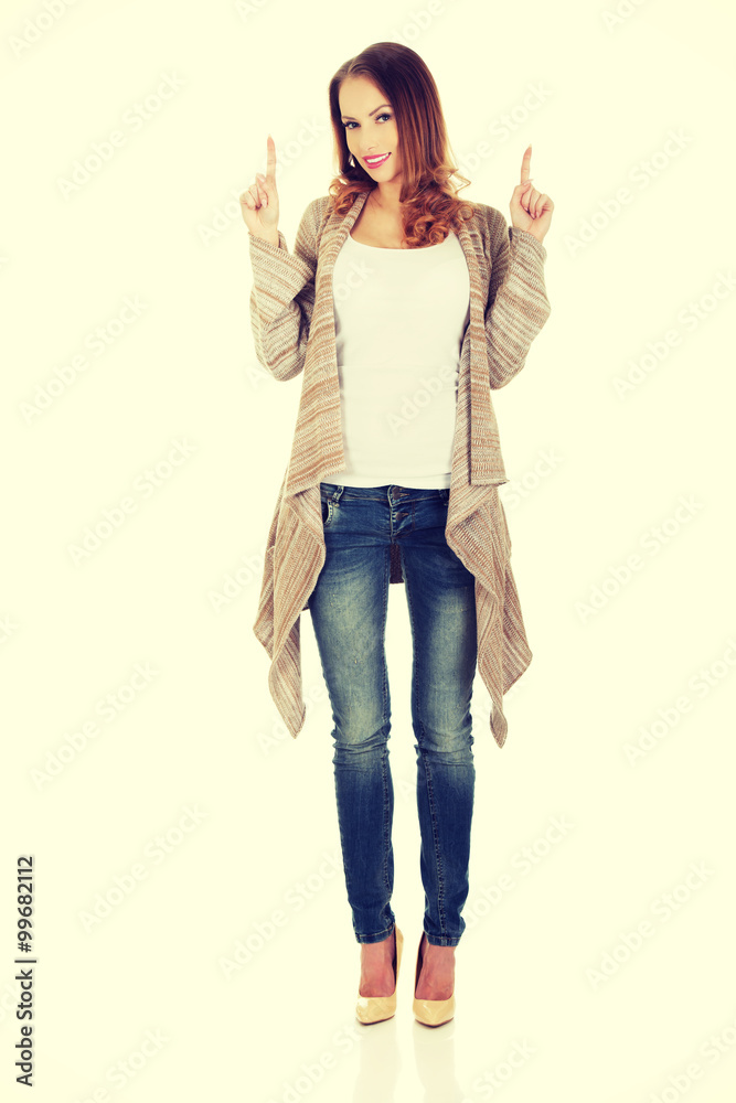 Happy smiling woman pointing up. Happy smiling woman pointing up.