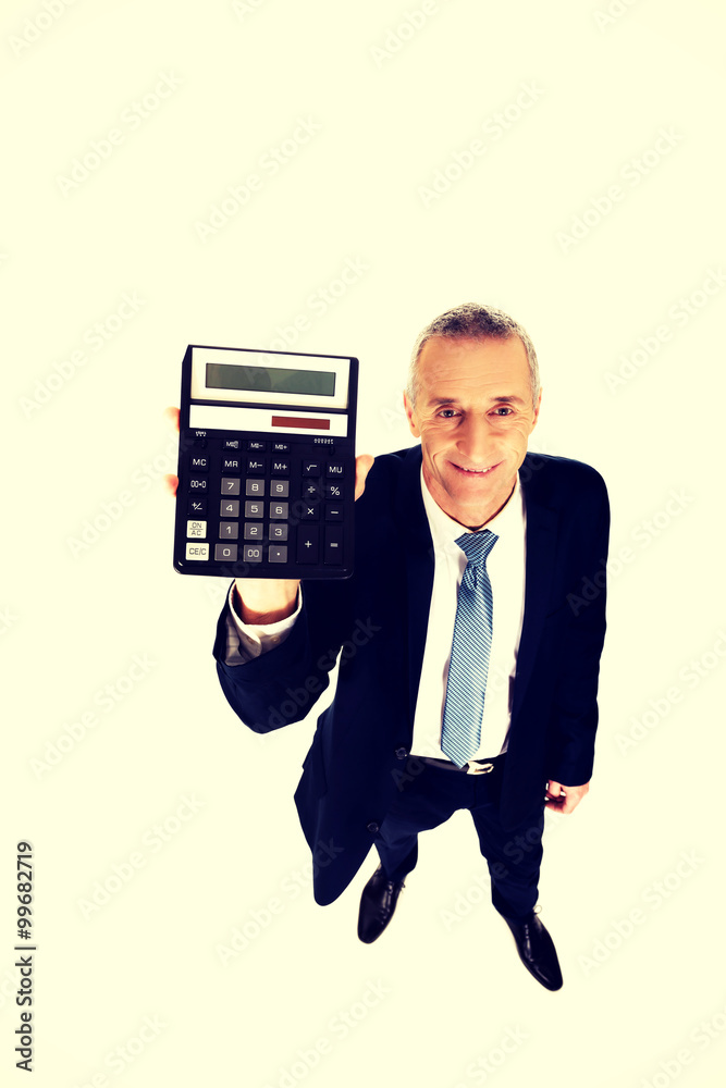 Happy businessman holding a calculator Happy businessman holding a calculator