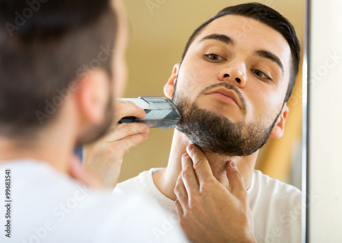 guy shaving by electric shaver