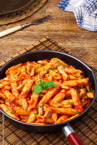 Penne with roasted chicken in tomato sauce