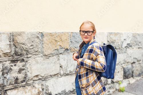 Cute little girl with backpack, back to school concept