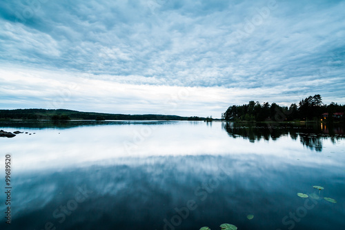 A beautiful view of a typical Swedish summer lake landscape at dusk. Location: Falun, Dalarna - Stora Vallan Lake.
 photo