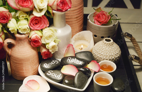 Roses spa with candle light
Spa equipment with pink and white roses on the black wooden tray 